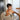 Toddler eating at the family dining table in the Cariboo Frankie Highchair (shown in Oat)