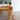 Toddler at the dining table in the Cariboo Frankie Highchair with tray removed (shown in Natural)